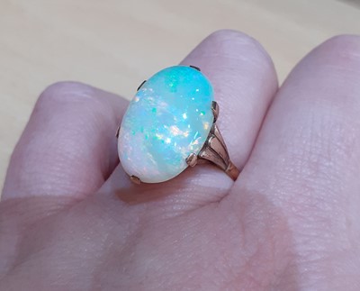 Lot 2074 - An Opal Ring the oval cabochon opal in a...