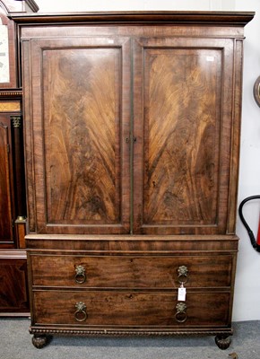 Lot 1131 - ~ A George III Figured Mahogany Press Cupboard,...