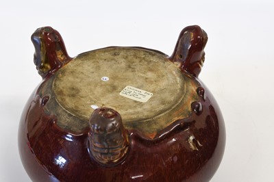 Lot 297 - A Chinese Sang de Boeuf-Glazed Tripod Censer,...