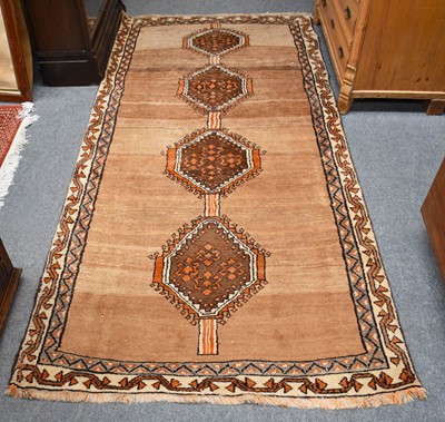 Lot 1231 - A Fars Rug, the abrashed camel field with four...