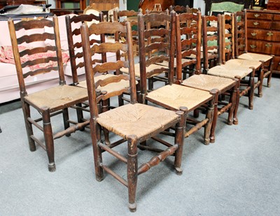 Lot 1300 - Twelve Similar Rush Seated Oak Ladder Back...