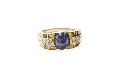 Lot 412 - A Sapphire and Diamond Ring, the oval cabochon...