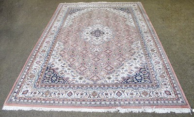 Lot 1261 - An Indian Carpet, the soft candy pink field...