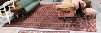 Lot 1249 - A Large "Bokhara" Carpet, the claret field...