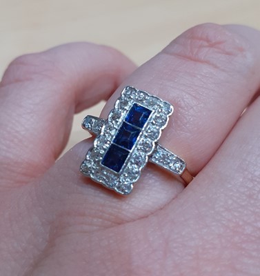Lot 2042 - A Sapphire and Diamond Cluster Ring three...