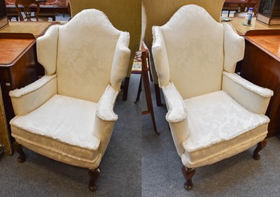 Lot 1303 - A Pair of 20th Century Wing Back Armchairs, in...