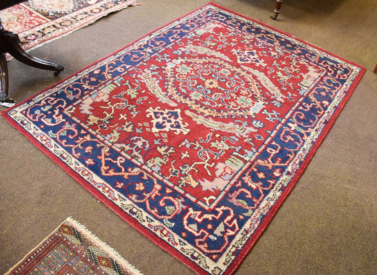 Lot 1261 - Indian Rug, the blood red field centered by