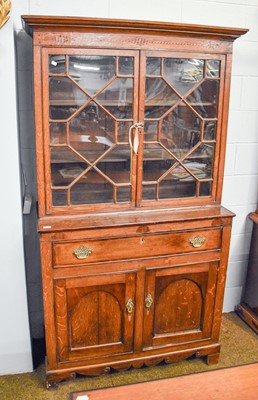 Lot 1310 - A George III Oak Bookcase, with an astragal...