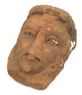 Lot 100 - A Celtic Red Stone Mask, carved with deep set...