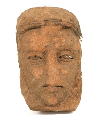 Lot 100 - A Celtic Red Stone Mask, carved with deep set...