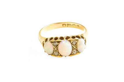 Lot 502 - An 18 Carat Gold Opal and Diamond Ring, three...