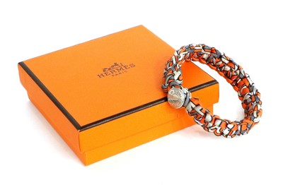 Lot 1097 - Hermés Silk Twill Woven Bracelet in orange,...