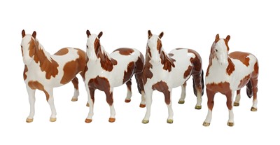 Lot 2182 - Beswick Pinto Ponies, model No. 1373, three...