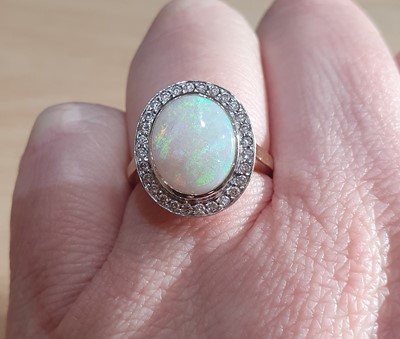 Lot 2056 - An Opal and Diamond Cluster Ring the oval...