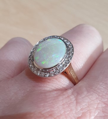 Lot 2056 - An Opal and Diamond Cluster Ring the oval...