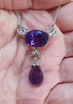 Lot 2046 - An Amethyst and Diamond Necklace the oval cut...