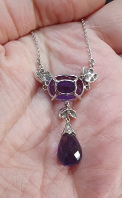 Lot 2046 - An Amethyst and Diamond Necklace the oval cut...