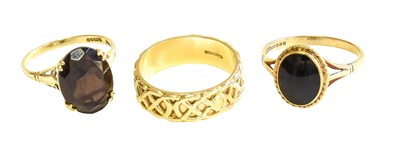 Lot 577 - A 14 Carat Gold Band Ring, finger size P; A 9...