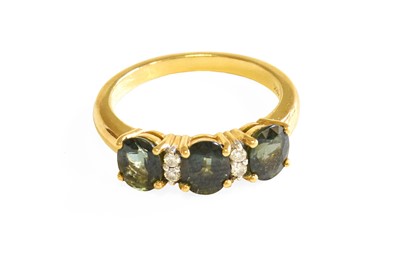 Lot 533 - A Green Sapphire and Diamond Ring, three oval...