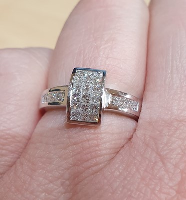 Lot 2018 - A Diamond Ring the rectangular cluster formed...