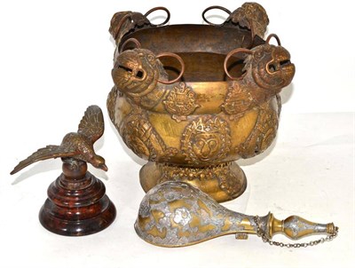 Lot 4 - A Tibetan brass bowl, Indian powder flask and a brass cast eagle mascot on base (3)
