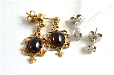 Lot 57 - A pair of diamond solitaire stud earrings and a pair of garnet drop earrings