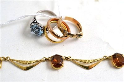 Lot 62 - A 22ct gold band ring, 9ct gold band ring, 9ct gold buckle ring, dress ring and a fancy link...