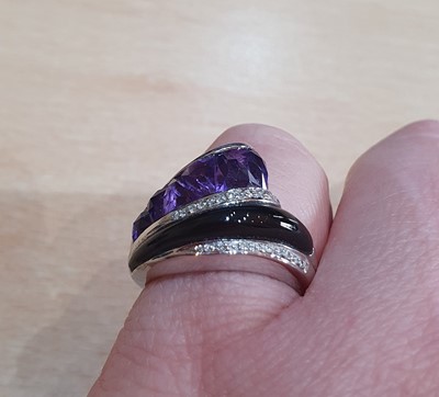 Lot 2051 - An Amethyst, Onyx and Diamond Ring, by...
