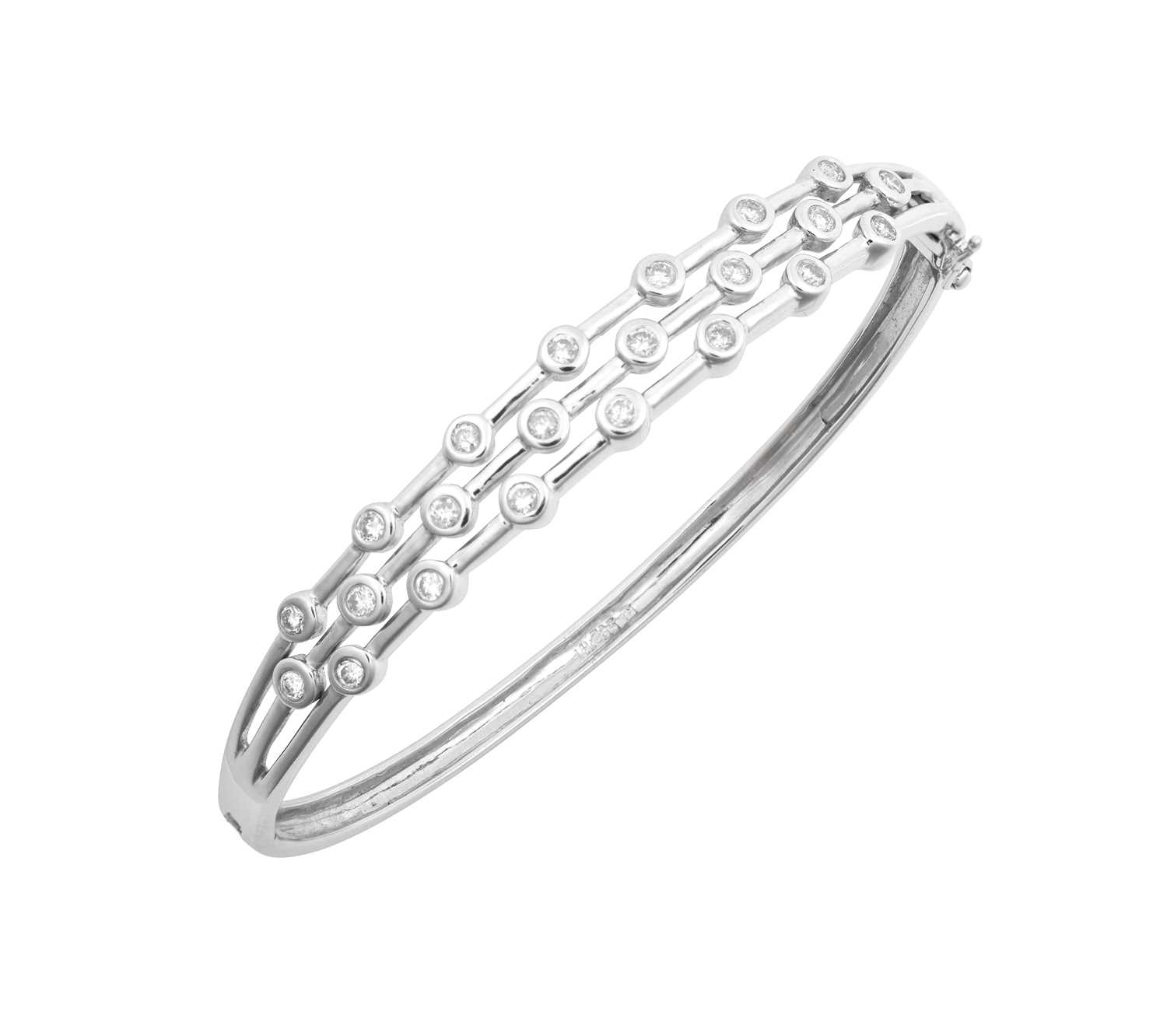 Lot 2033 - A Diamond Bangle three rows of round brilliant...