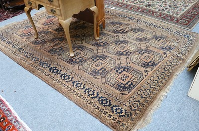 Lot 1117 - Afghan Turkmen Carpet, the walnut brown field...