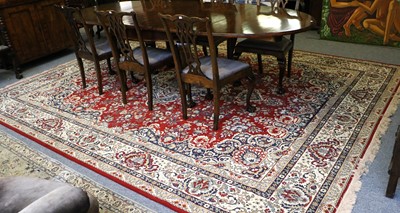 Lot 1121 - Machine Made Carpet, the deep brick red field...