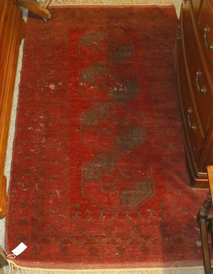 Lot 1130 - Afghan Rug, the claret field with four...