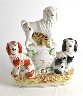 Lot 117 - Staffordshire clock group with three dogs