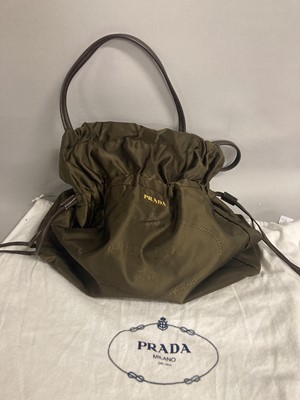 Lot 1090 - Prada Brown Drawstring Tote Handbag, with gold-...