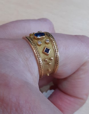 Lot 2033 - A Sapphire and Diamond Ring the oval cut...