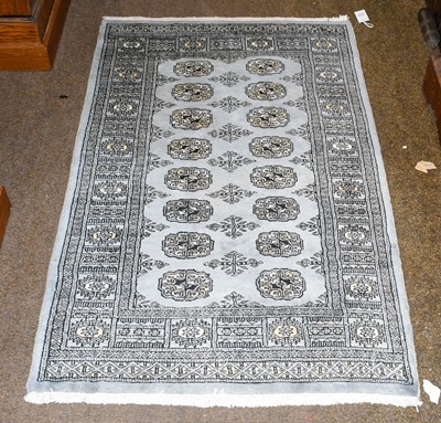 Lot 1010 - "Bukhara" Rug, the steel blue field with two...