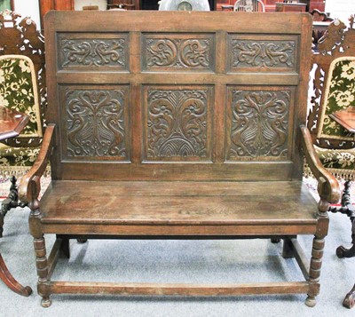 Lot 1384 - An 18th Century Style Carved Oak Settle, with...