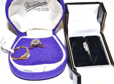 Lot 175 - A diamond solitaire ring, a diamond three stone ring and a diamond cluster ring