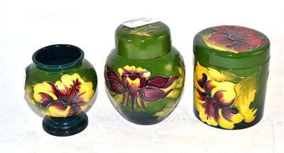 Lot 184 - A Moorcroft pottery ginger jar and cover, a baluster vase and a cylindrical jar and cover