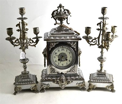 Lot 219 - A chromium plated three piece clock garniture