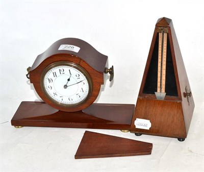 Lot 228 - An Edwardian mahogany vase shape mantel clock and a mahogany metronome