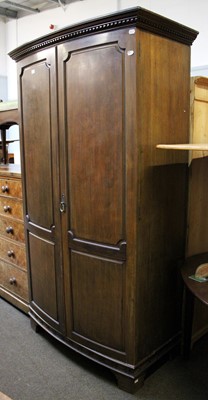 Lot 1301 - A Maple & Co. Mahogany Bow Fronted Wardrobe,...