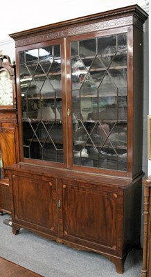 Lot 1133 - A George III Mahogany Bookcase, the dentil...