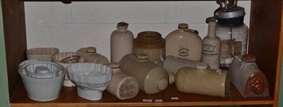 Lot 299 - Assorted pottery storage jars, butter mixer, pottery moulds, three brass jam pans etc (one shelf)