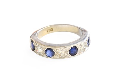 Lot 217 - A Sapphire and Diamond Half Hoop Ring, four...