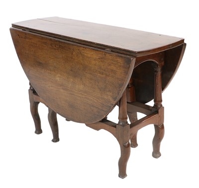 Lot 1117 - A George II Four-to-Six-Seater Oak Gateleg...