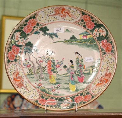 Lot 324 - A Japanese charger decorated in the famille rose palette, 39cm diameter