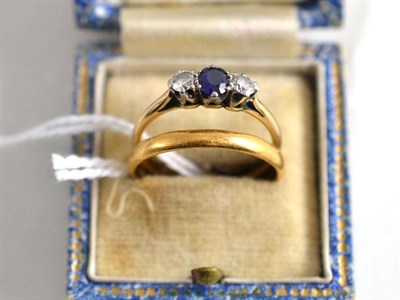 Lot 337 - A 22ct gold band ring and a sapphire and diamond three stone ring, stamped 'PLAT' and '18CT' (2)