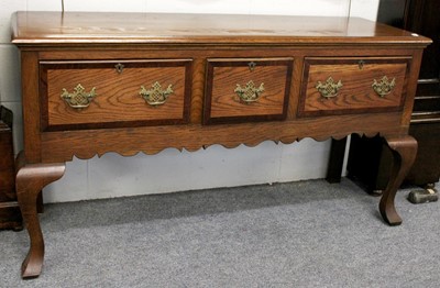 Lot 1099 - A Three Drawer Oak Dresser Base, 20th century,...