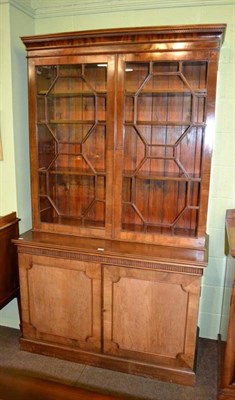 Lot 397 - A mahogany bookcase with astragal glazed doors over two cupboard doors